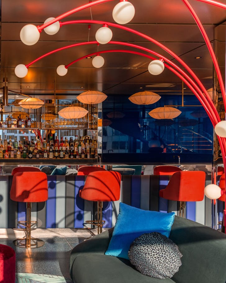 A brightly lit, colourful bar with red embellishments