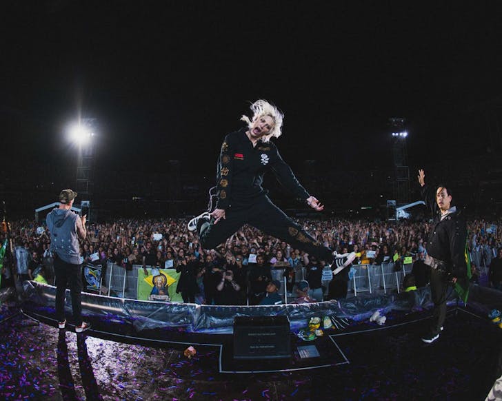 Linkin Park rock out on stage.