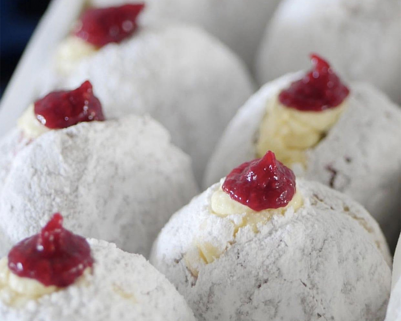 Diplomat donuts bursting with cream and raspberry coulis
