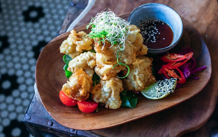 crispy cauliflower bites on a plate with sauce