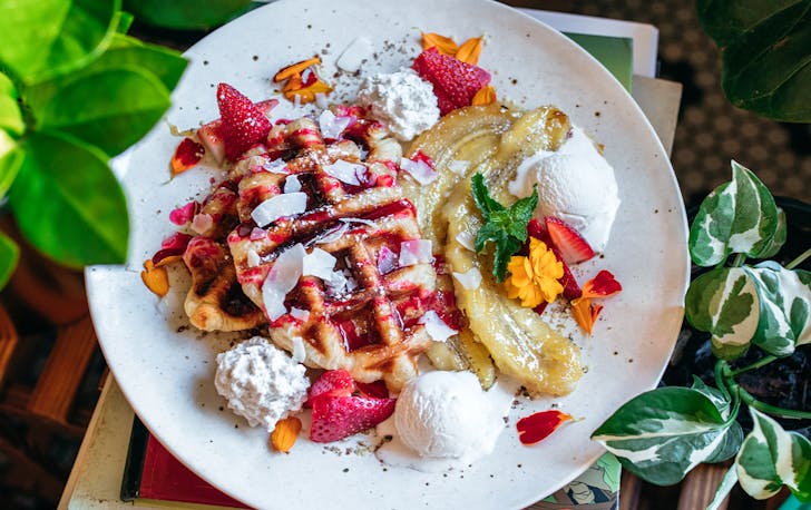 a plate of waffles with banana