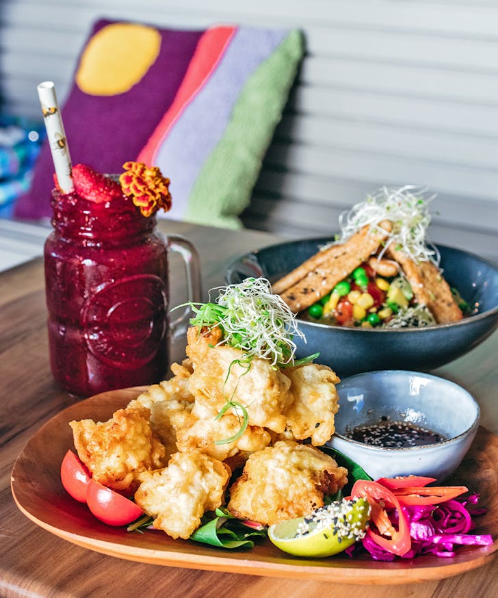 several dishes and a smoothie on a table