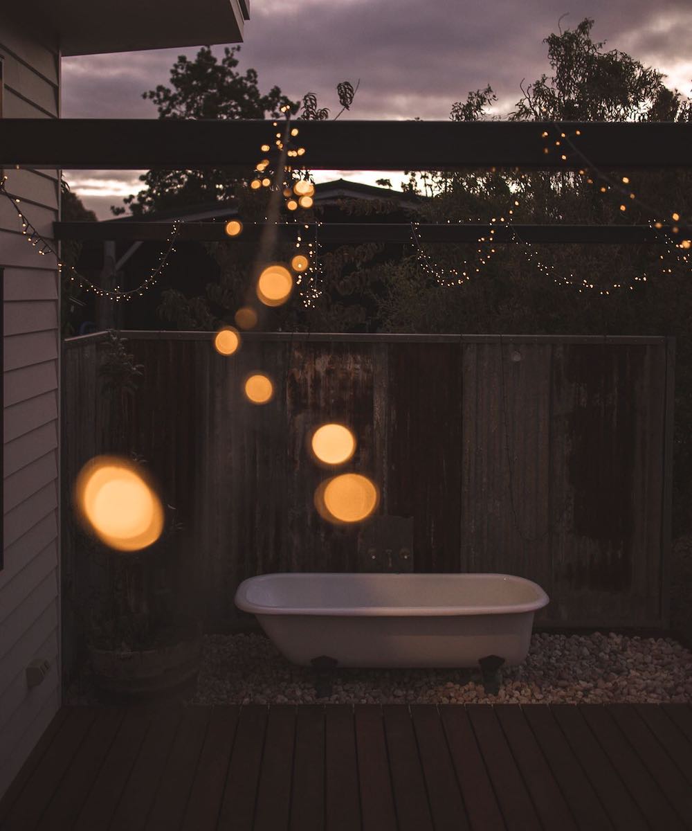 An outdoor tub with fairy lights