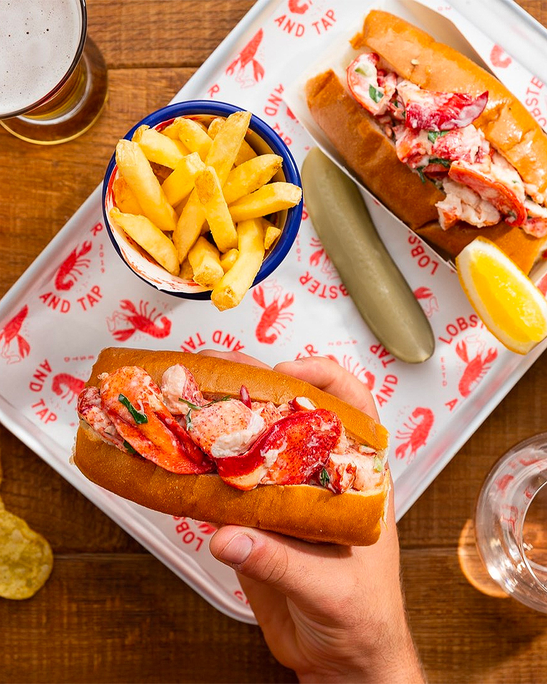 Someone holds a lobster roll.