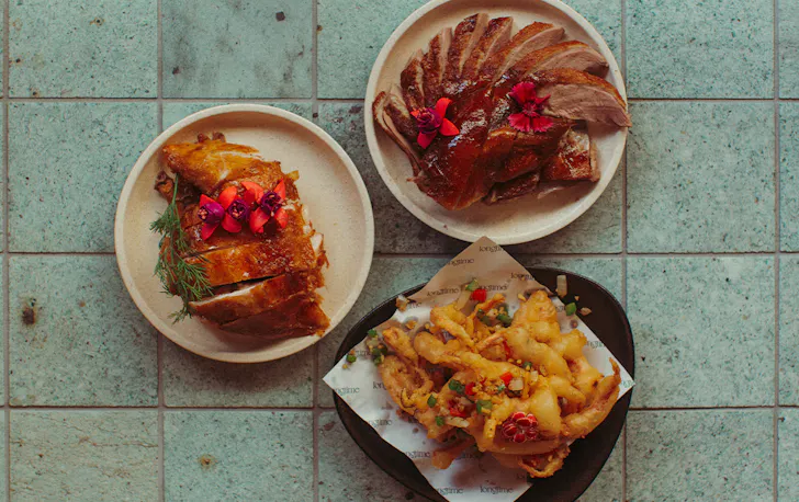 three different plates of Cantonese style food on a table, seen top down