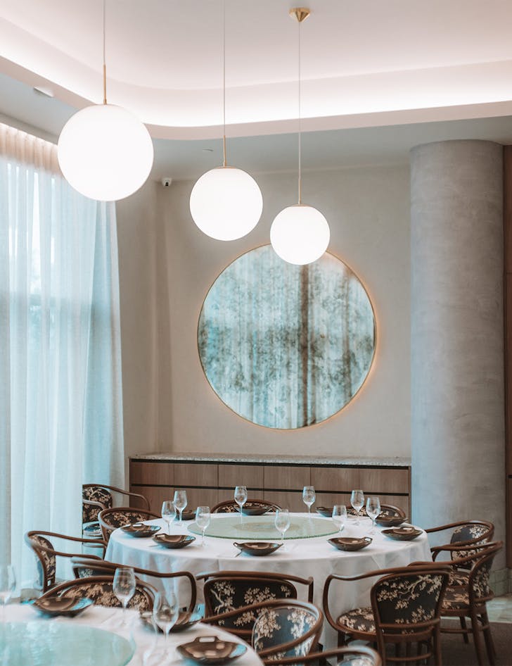 a round table with cherry blossom patterned seats in a restaurant