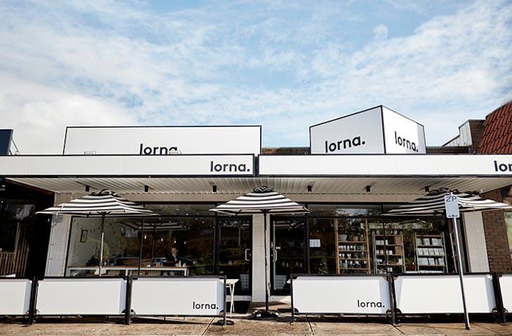 White cafe stands and umbrellas branded with the name 'lorna' at a cafe in Ferntree Gully serving one of the best breakfast in Melbourne.