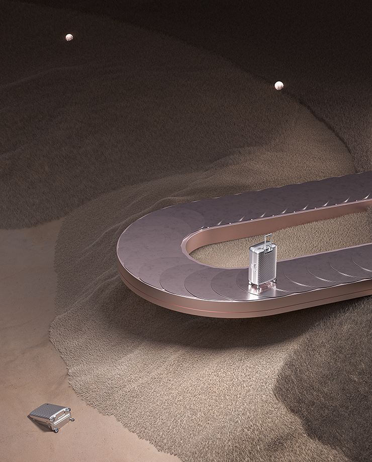 A luggage conveyor belt in the desert. Chrome luggage is on the belt and sitting in the sand.