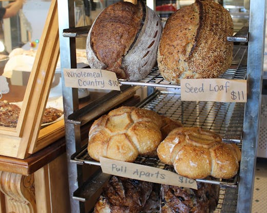 Freshly baked sourdough loaves cooling on a rack at Luca Bakery in Castle Hill.