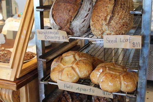 Freshly baked sourdough loaves cooling on a rack at Luca Bakery in Castle Hill.