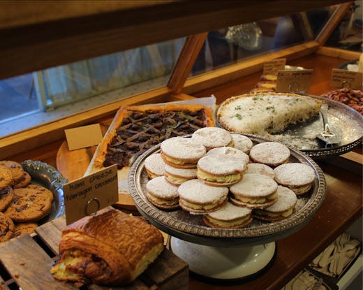 Trays of freshly baked biscuits displayed inside a glass cabinet at Luca Bakery in Castle Hill.