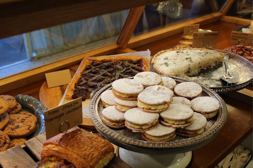 Trays of freshly baked biscuits displayed inside a glass cabinet at Luca Bakery in Castle Hill.