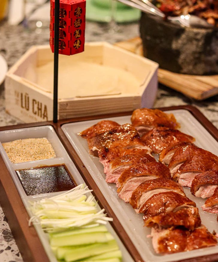 peking duck served with pancakes and sides