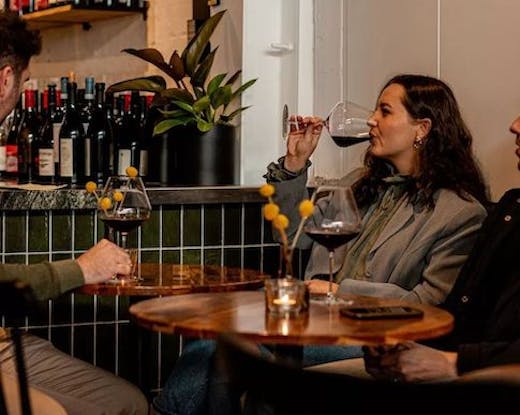 Woman drinking wine at Lums Wine Bar.