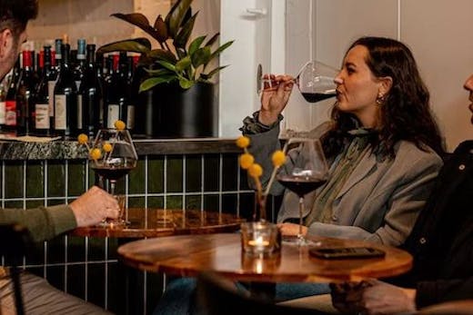 Woman drinking wine at Lums Wine Bar.