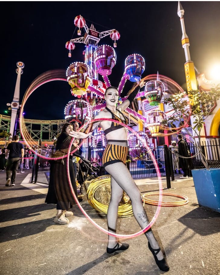 A performer dressed in spooky costume for a halloween theme at luna park