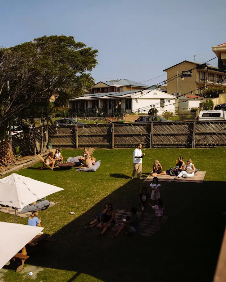 Families relax on the grass of the casual beer garden at Lynch's Narooma.