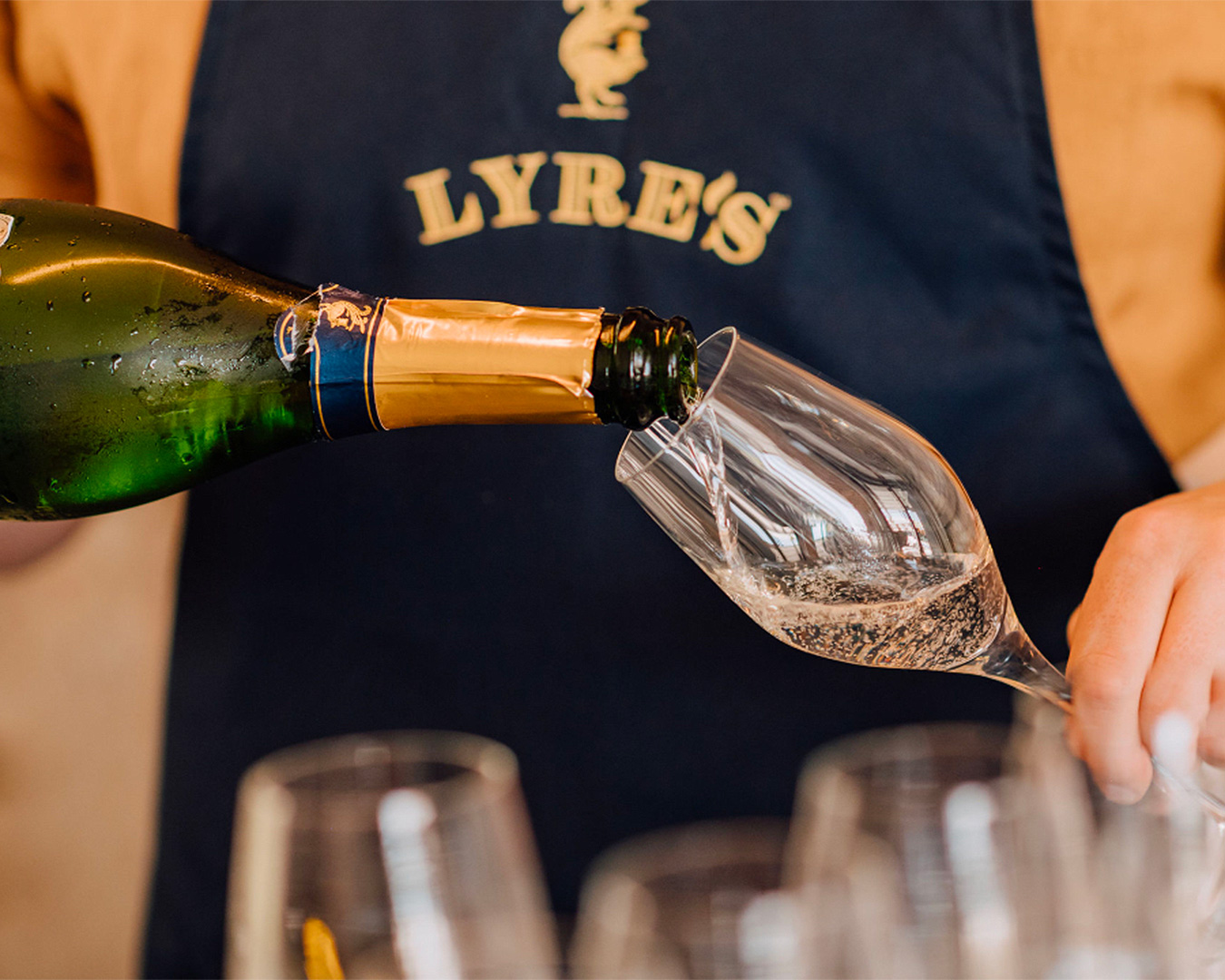 Someone pours out a glass of Lyre's Classico Prosecco, one of the best non alcoholic sparkling wines in australia.