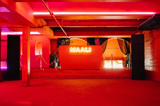 A dance floor with cherry red walls at Maali in Sydney