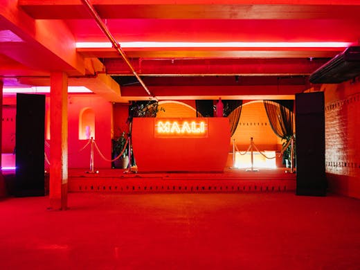 A dance floor with cherry red walls at Maali in Sydney