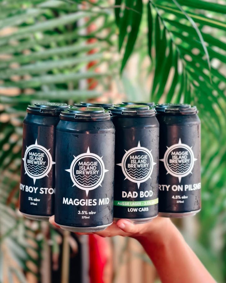 Stack of beer cans brewed onsite at Maggie Island Brewery.