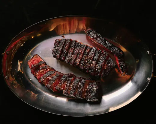 Charcoal-grilled wagyu steak, sliced and served medium rare with a deeply caramelised crust and sea salt.
