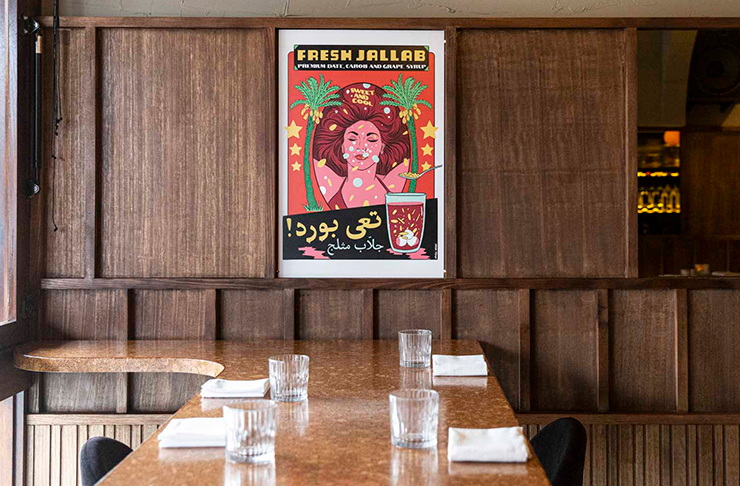 A framed print on a wall and a wood-grain bar at one of the best vegetarian restaurants in Melbourne