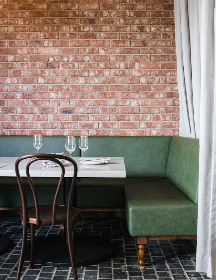 a green leather booth