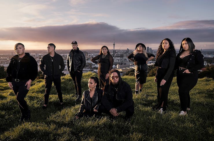 Members of the band Maimoa stand on the top of Mount Eden.