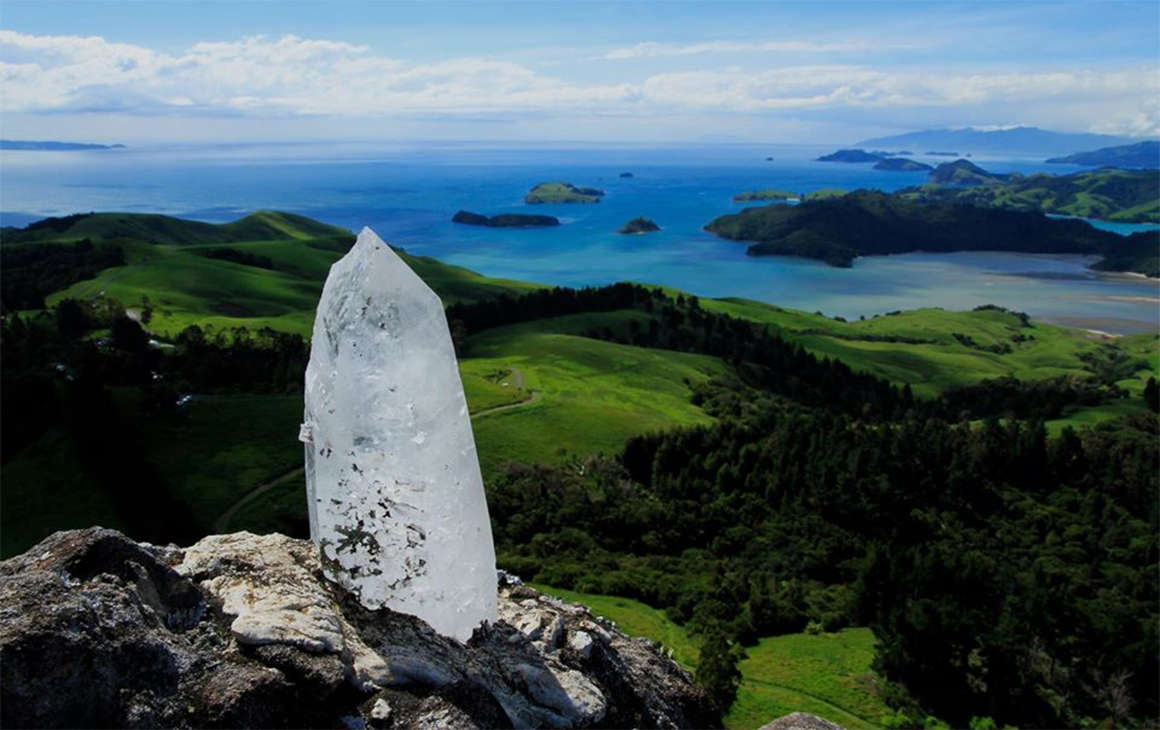 A crystal in the ground in front of an amazing view at Mana Retreat, one of NZ's best retreats.