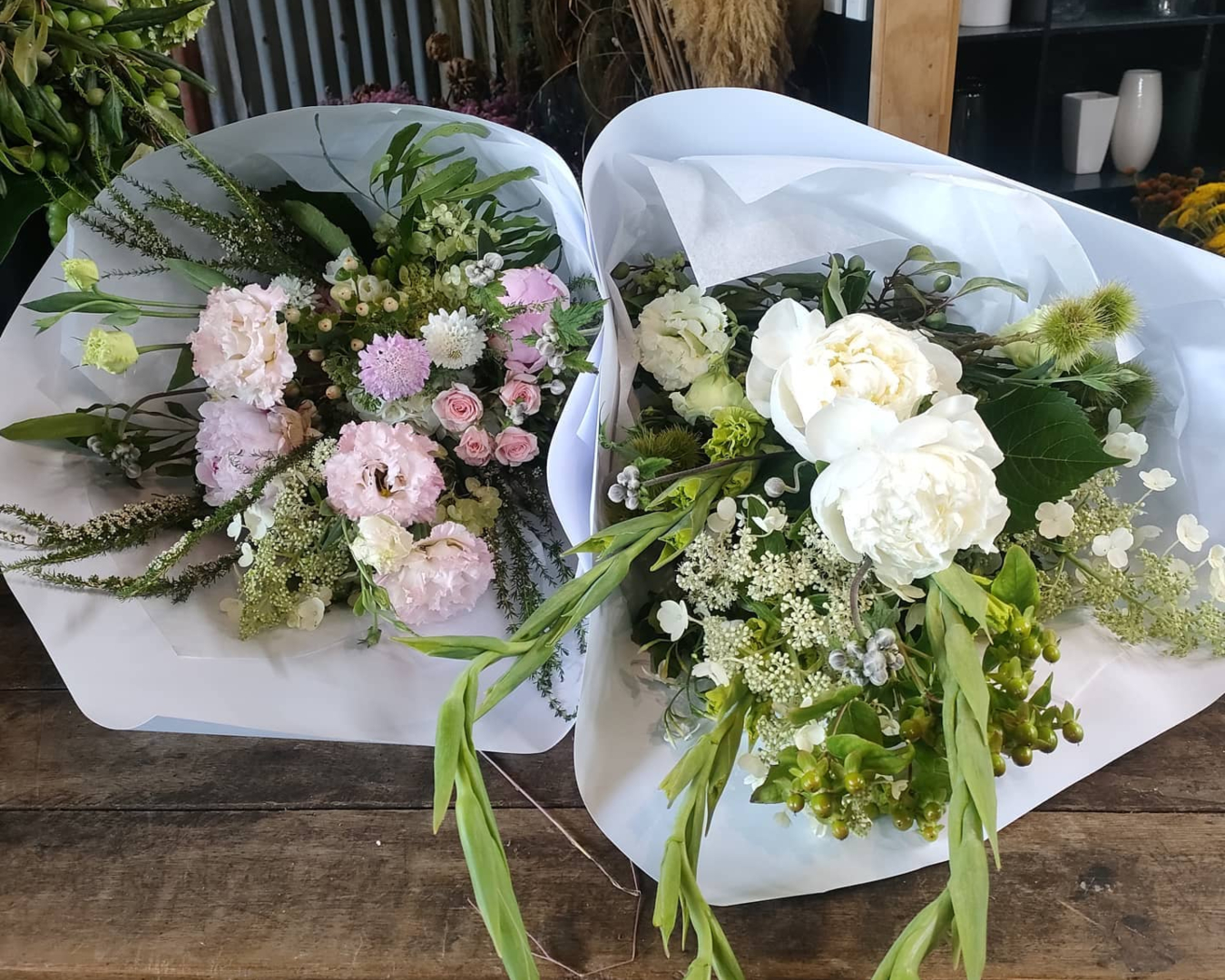 Two beautiful, pastel bouquets from Flowers Manuela sit side-by-side