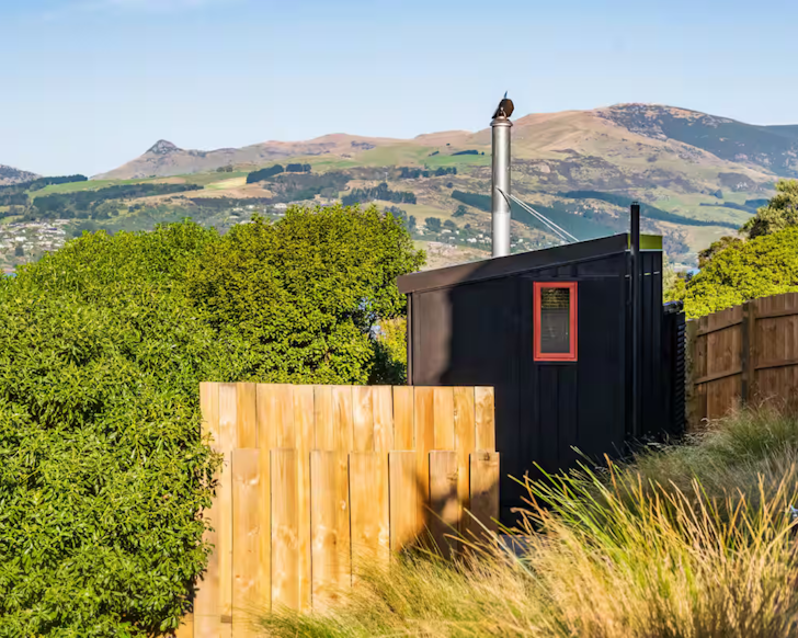 mariner's cabin christchurch airbnb tiny home with mountain view backdrop
