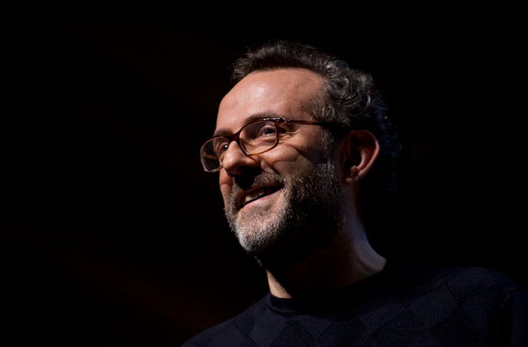 One of the world's most renowned chefs, Massimo Bottura, smiling contently at the camera.