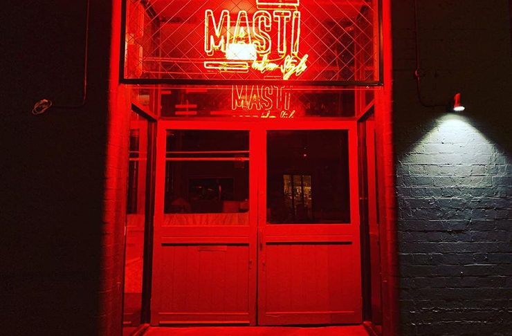 A neon-lit interior with a red neon sign that reads 