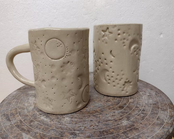 Two cute, handmade Matariki mugs.