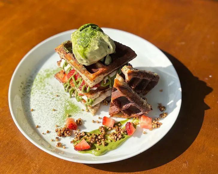 A stack of sweet waffles with matcha ice cream at Janken.