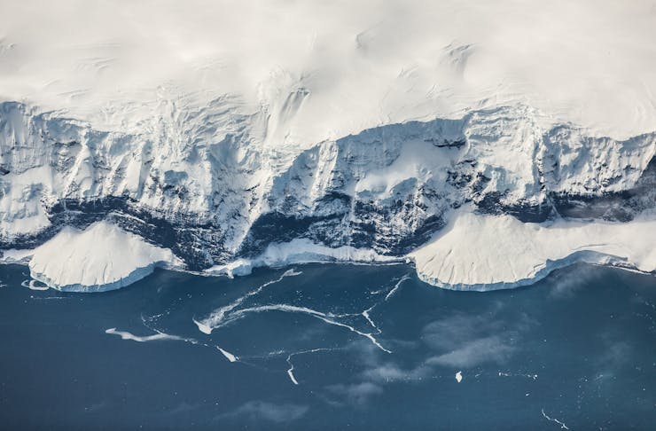 The snow-covered cliffs of Antarctica's coastline.