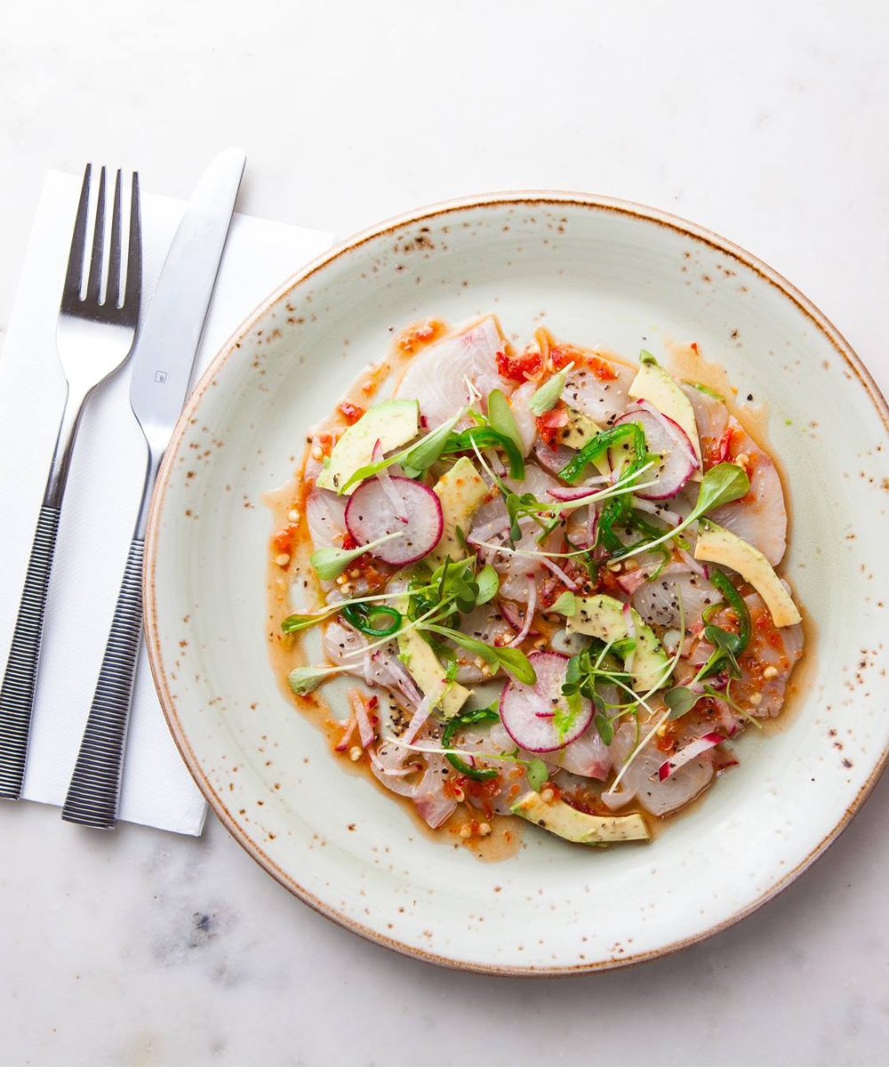 a plate of avo topped ceviche