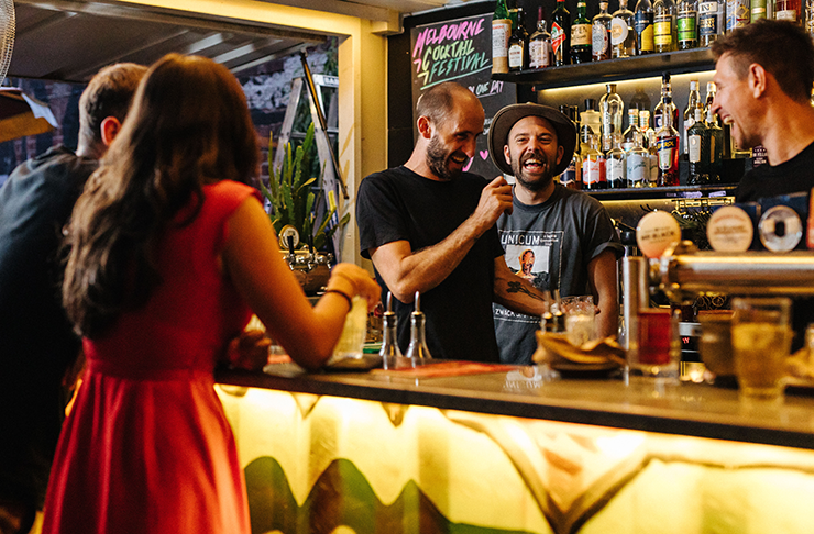 People drinking and laughing at the Melbourne Cocktail Festival.