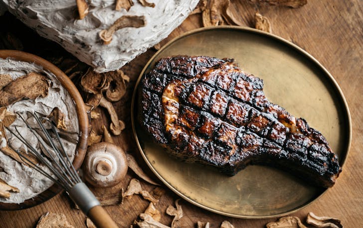A seared rib eye on a table at one of Meat&WineCo, one of the best Southbank restaurants.