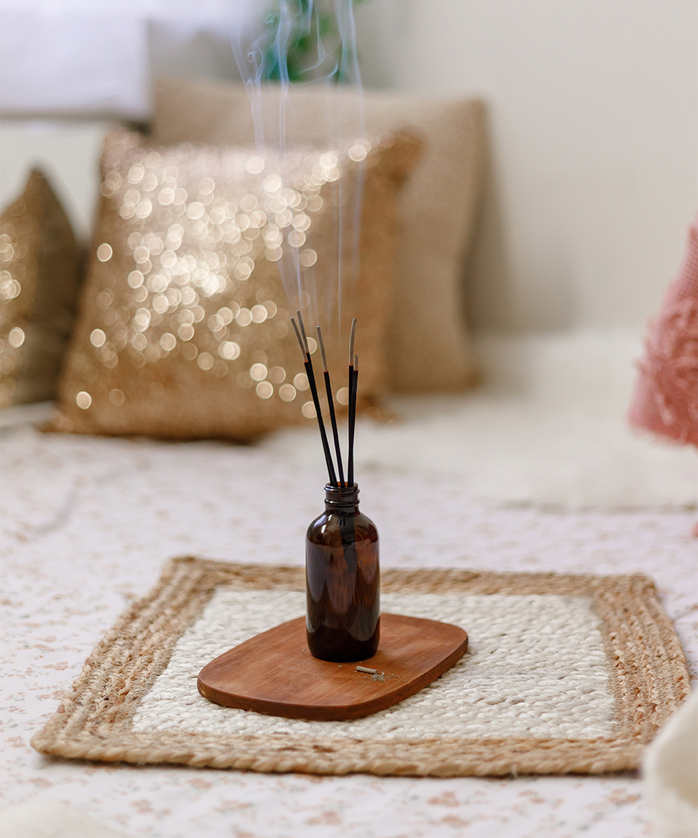 an incense burner on a wooden plate