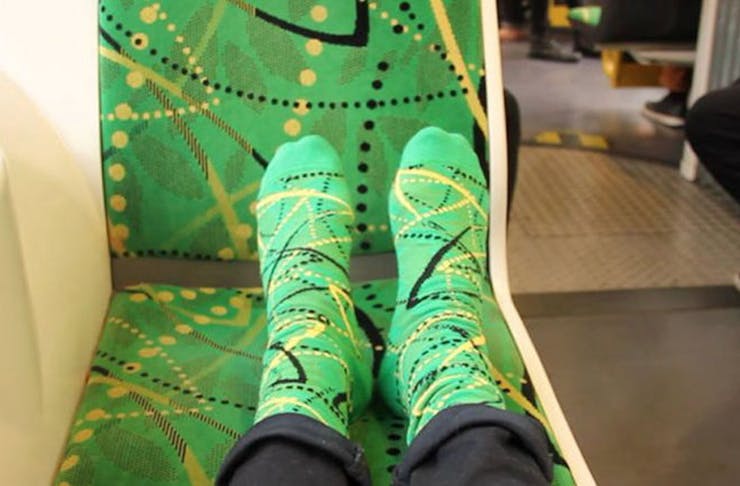 Feet adorning socks in the same fabric as Melbourne's tram seats.