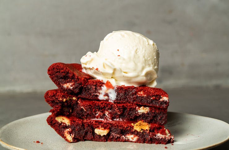 A slice of Messina's limited-edition red velvet cookie pie, topped with a scoop of Messina gelato. 
