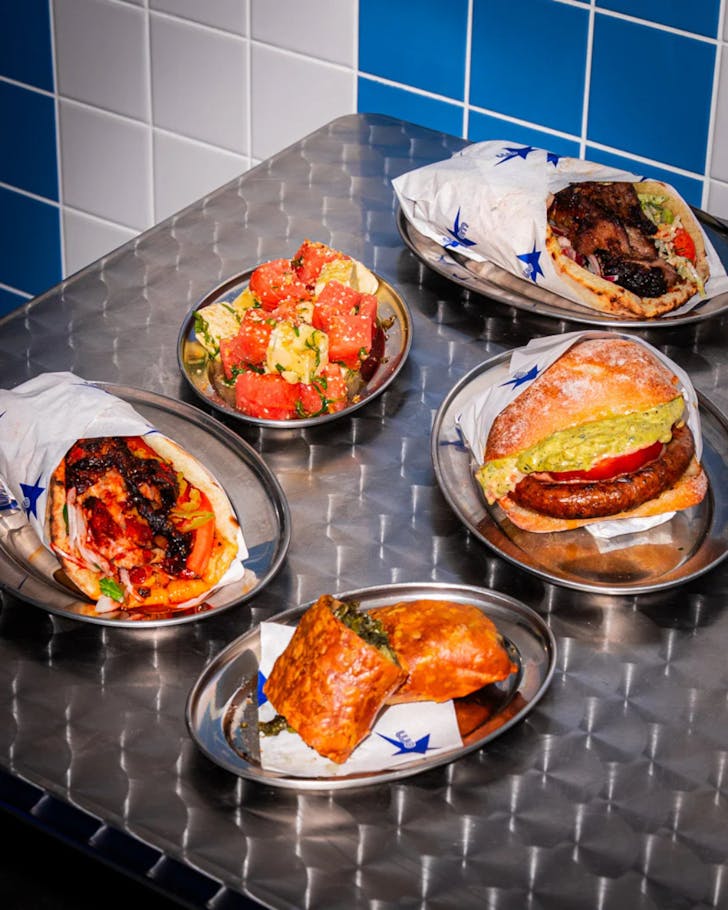 messina eats olympic meats various greek dishes displayed on a table