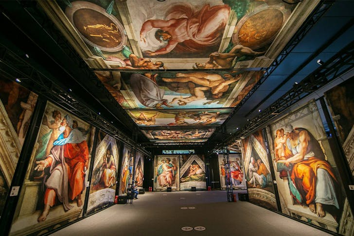 panels of the sistine chapel artworks displayed in an exhibition hall