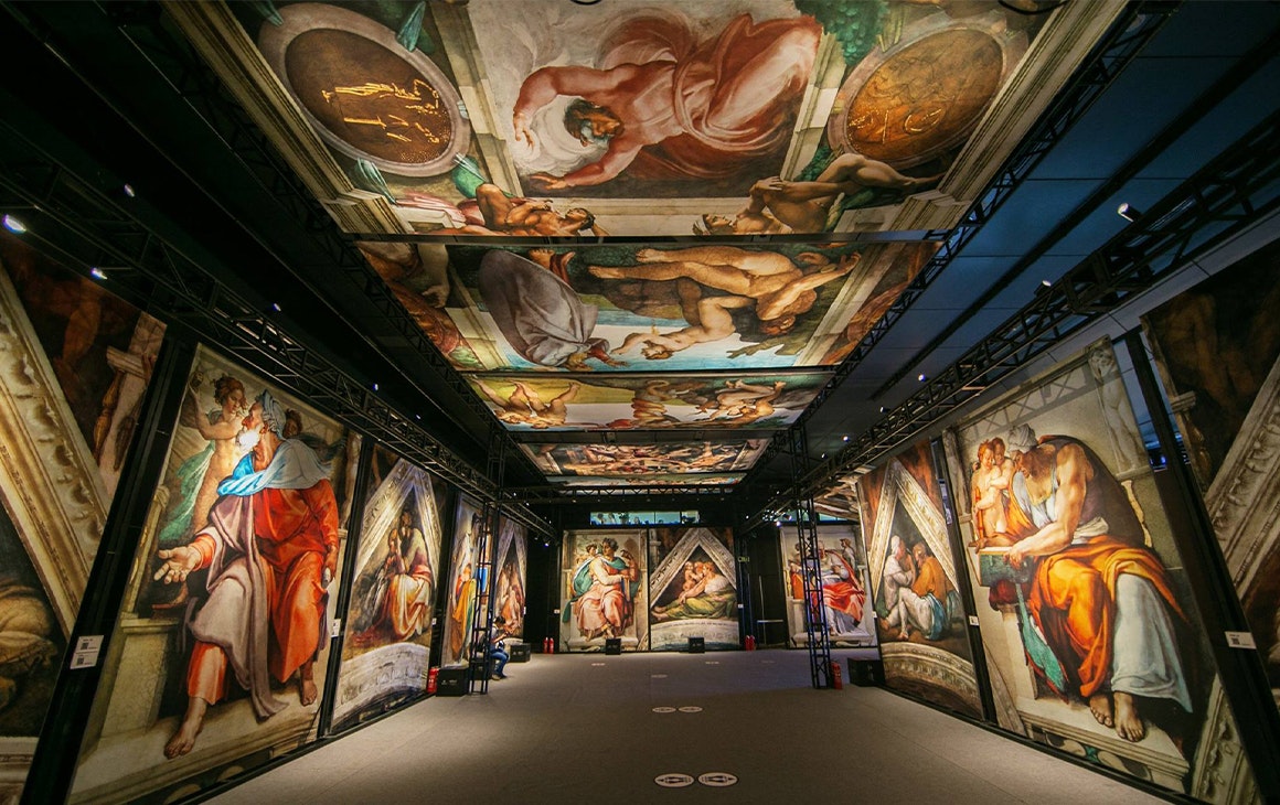 panels of the sistine chapel artworks displayed in an exhibition hall