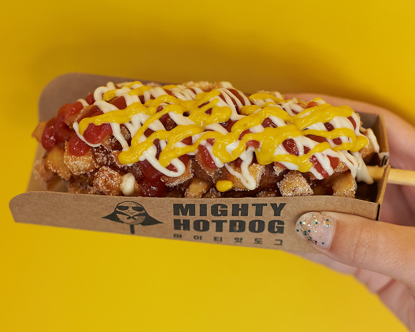 Heaping sauce onto your Mighty Hotdog is a right of passage on Auckland's cheap eats scene.