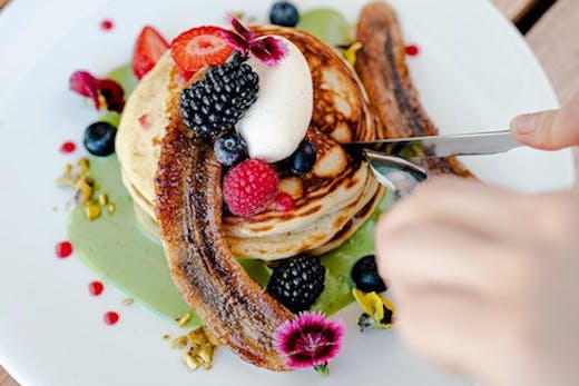 a stack of pancakes from Mimosa