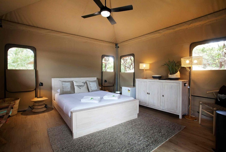 A view of the bed in a tent at Minjerribah Camping one of the best Glamping spots in Queensland