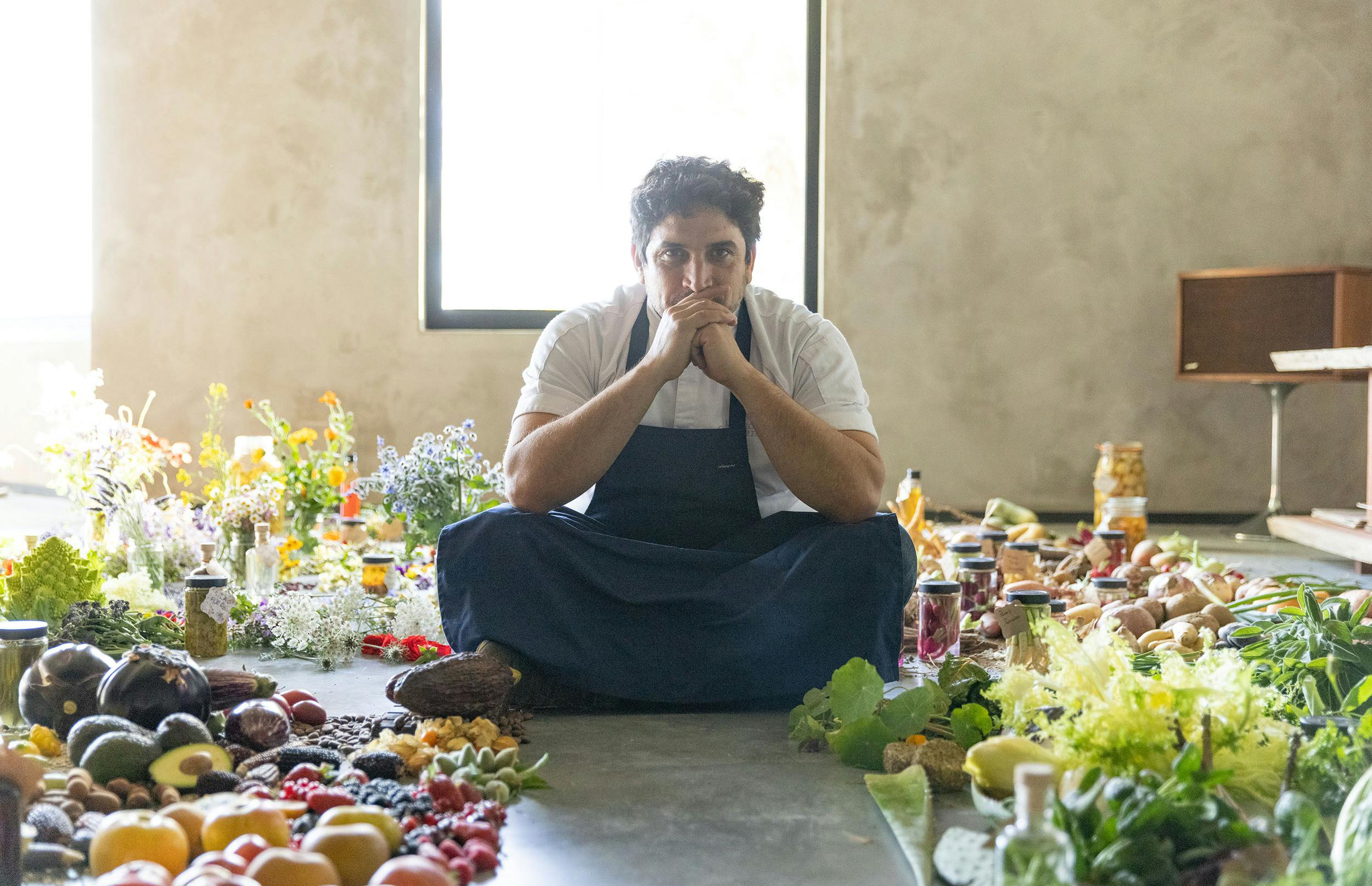 Mauro Colagreco sits with produce from his restaurant Mirazur
